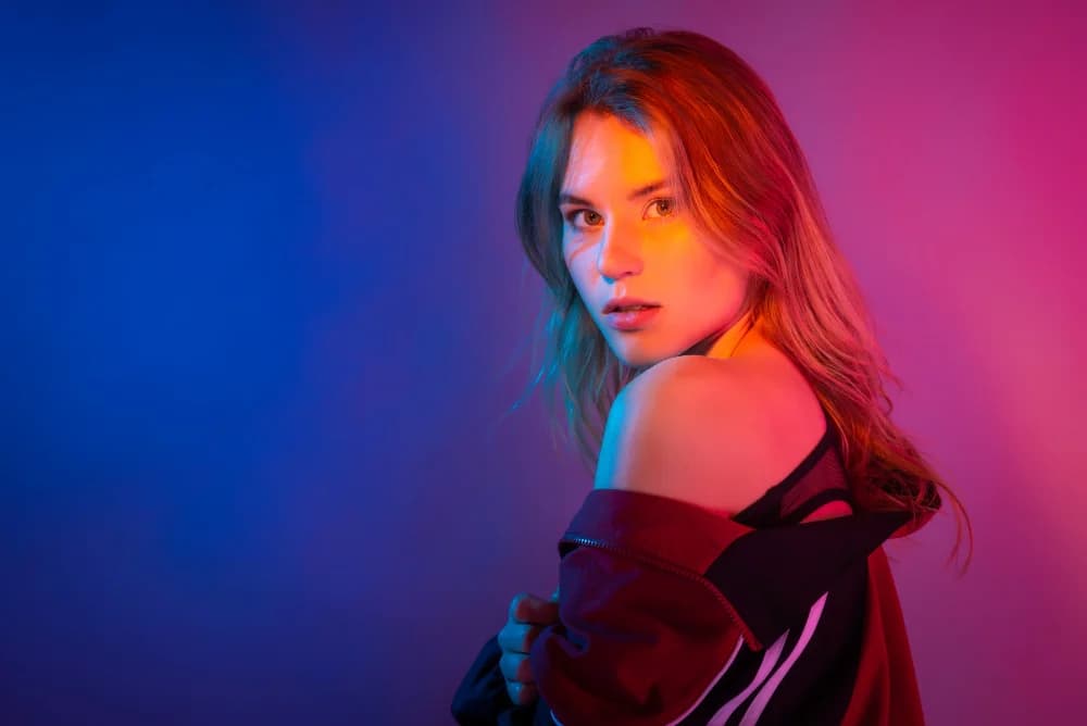 Creative professional in blue and magenta studio lighting